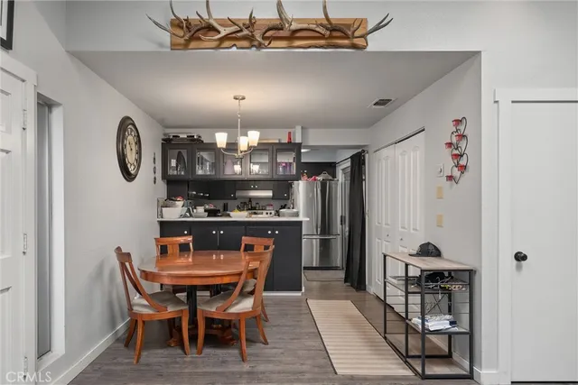 a kitchen with a dining table and stainless steel appliances