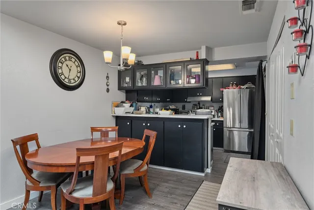 a living room with furniture and a flat screen tv with wooden floor