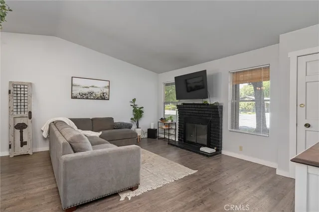 a living room with furniture a fireplace and a flat screen tv