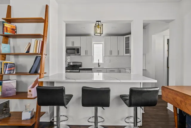 a living room with lots of furniture and a chandelier