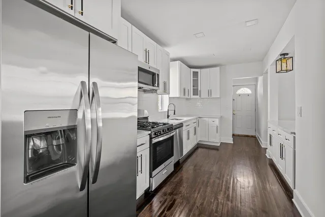a living room with furniture a rug and a bookshelf