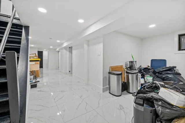 a bedroom with a bed and large windows