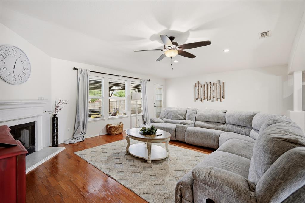 1213 Hampton Drive Forney, TX 75126 - Photo 14 of 27 a living room with furniture a fireplace and a potted plant