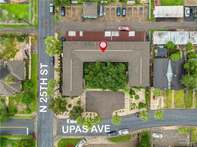 an aerial view of residential houses with outdoor space and seating