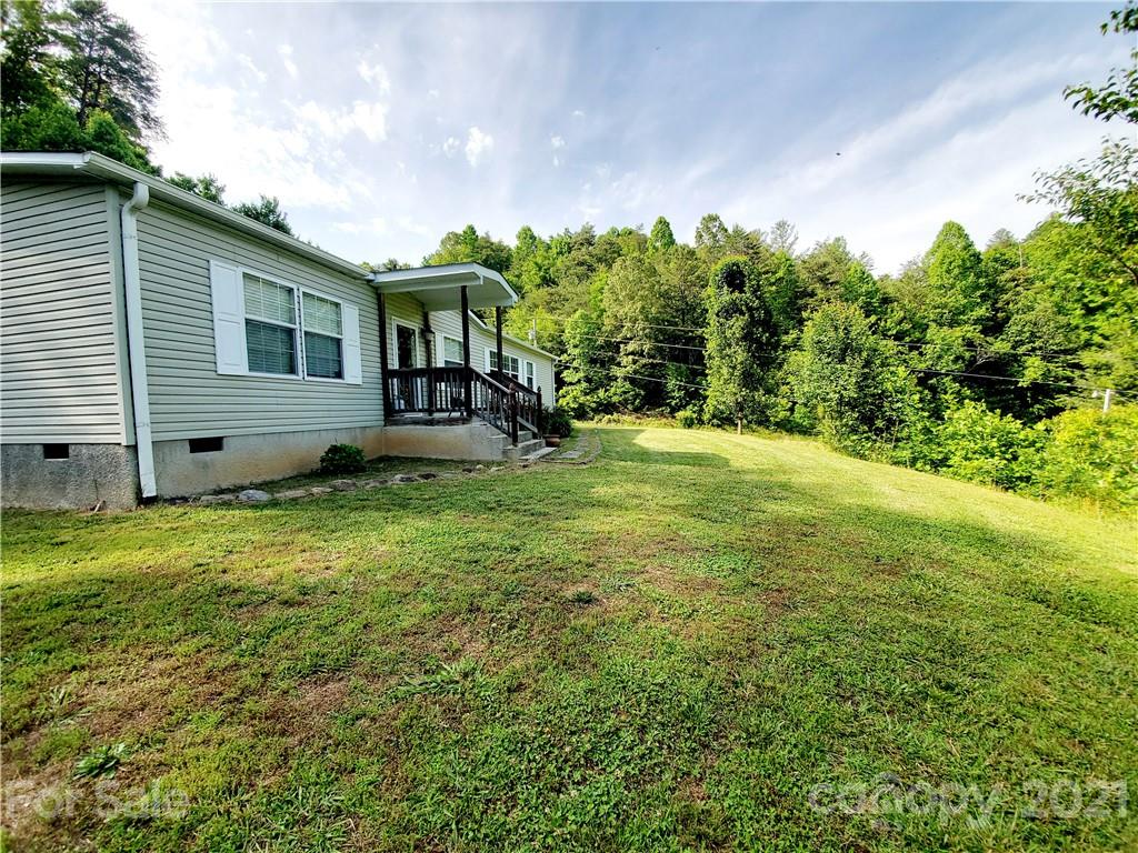 655 Sandy Bottom Road Marshall, NC 28753 - Photo 22 of 29 a view of a house with backyard and sitting area