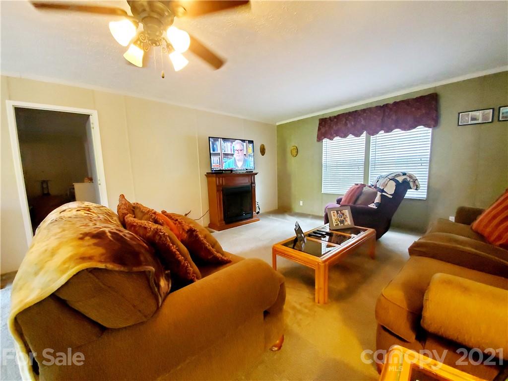 655 Sandy Bottom Road Marshall, NC 28753 - Photo 4 of 29 a bedroom with two beds and a chandelier