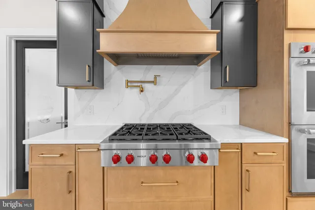a large white kitchen with a large window
