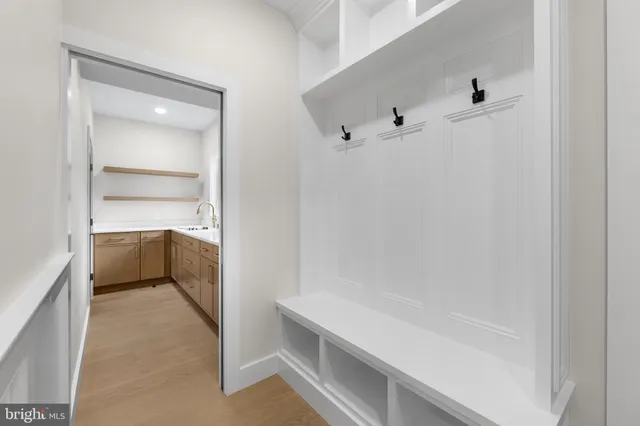 a view of a hallway with a chandelier fan