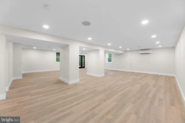 a spacious bathroom with a large tub and large windows