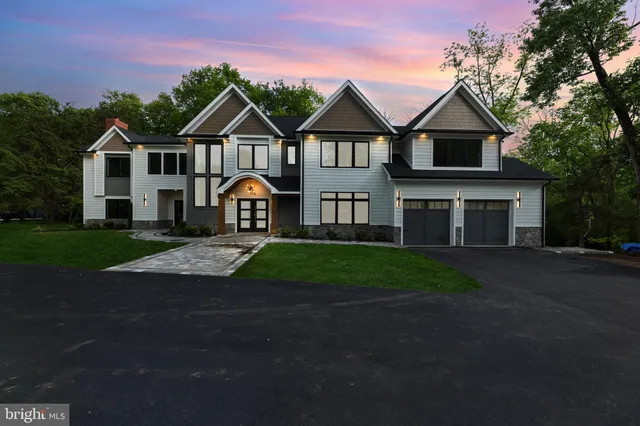 a large living room with stainless steel appliances kitchen island granite countertop a large window and a couch