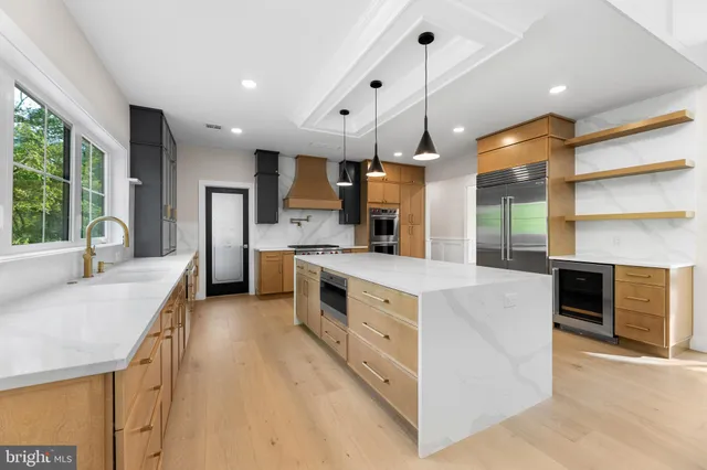 a kitchen with stainless steel appliances a sink a stove and a refrigerator