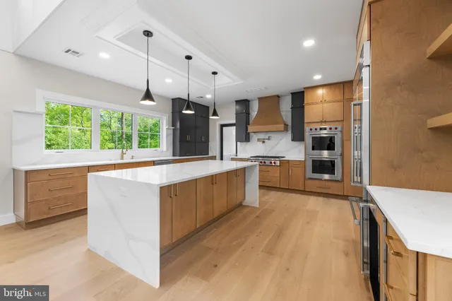 a kitchen with cabinets appliances and a sink