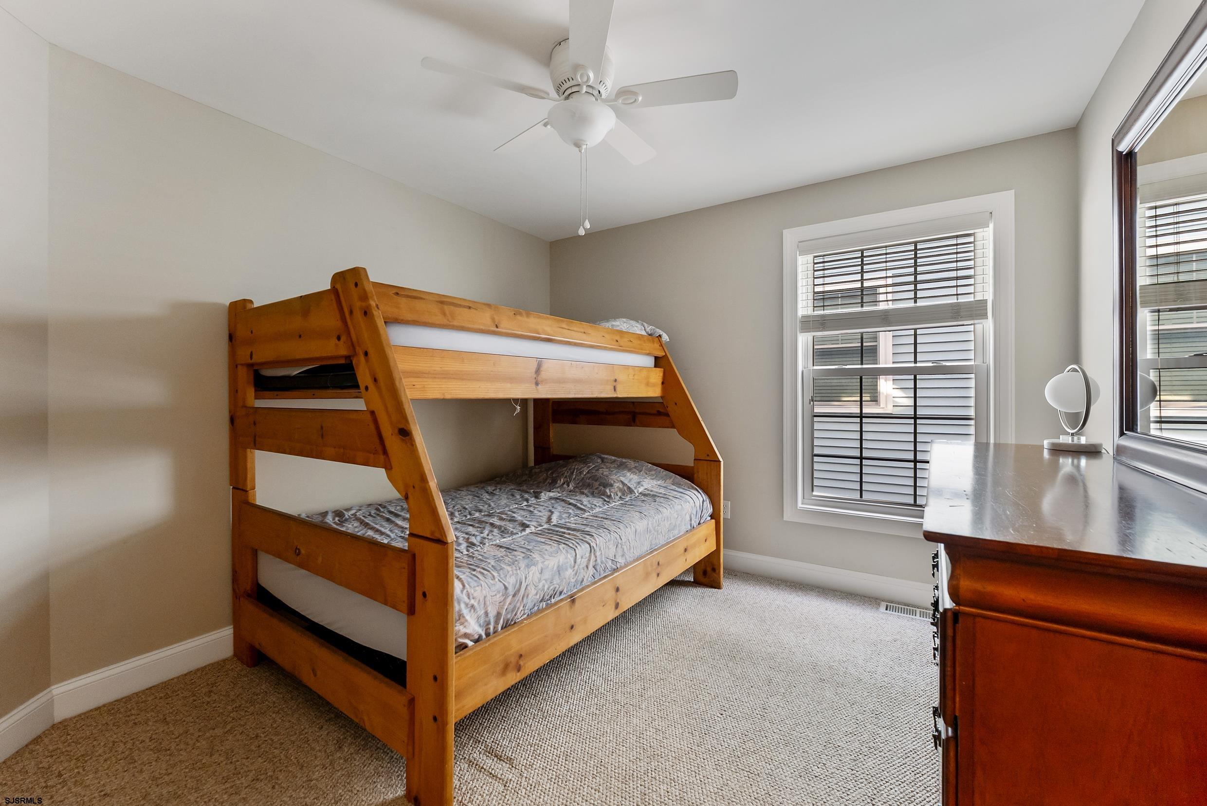 909 East 4th Street, Unit 1 Ocean City, NJ 08226 - Photo 21 of 47 a bedroom with bed and window