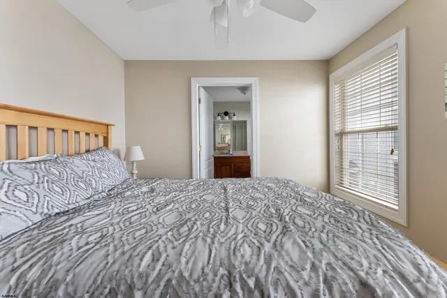 a bedroom with a large bed and a window