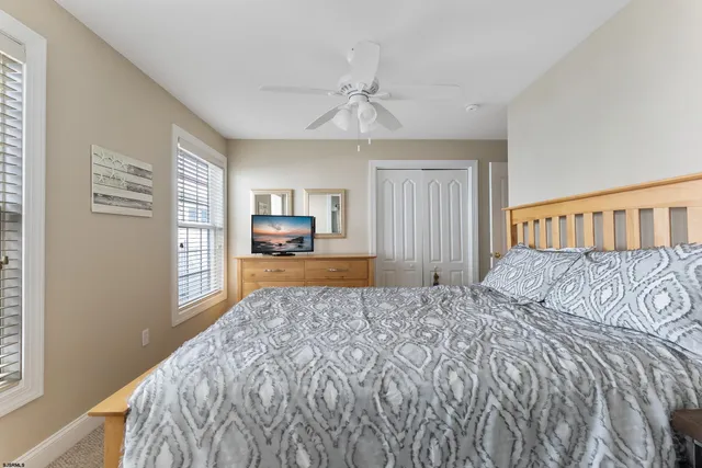 a bedroom with a large bed and a window