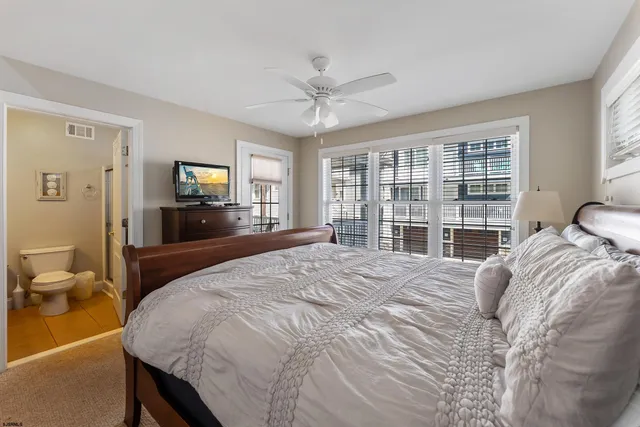 a bedroom with a large bed and a large window