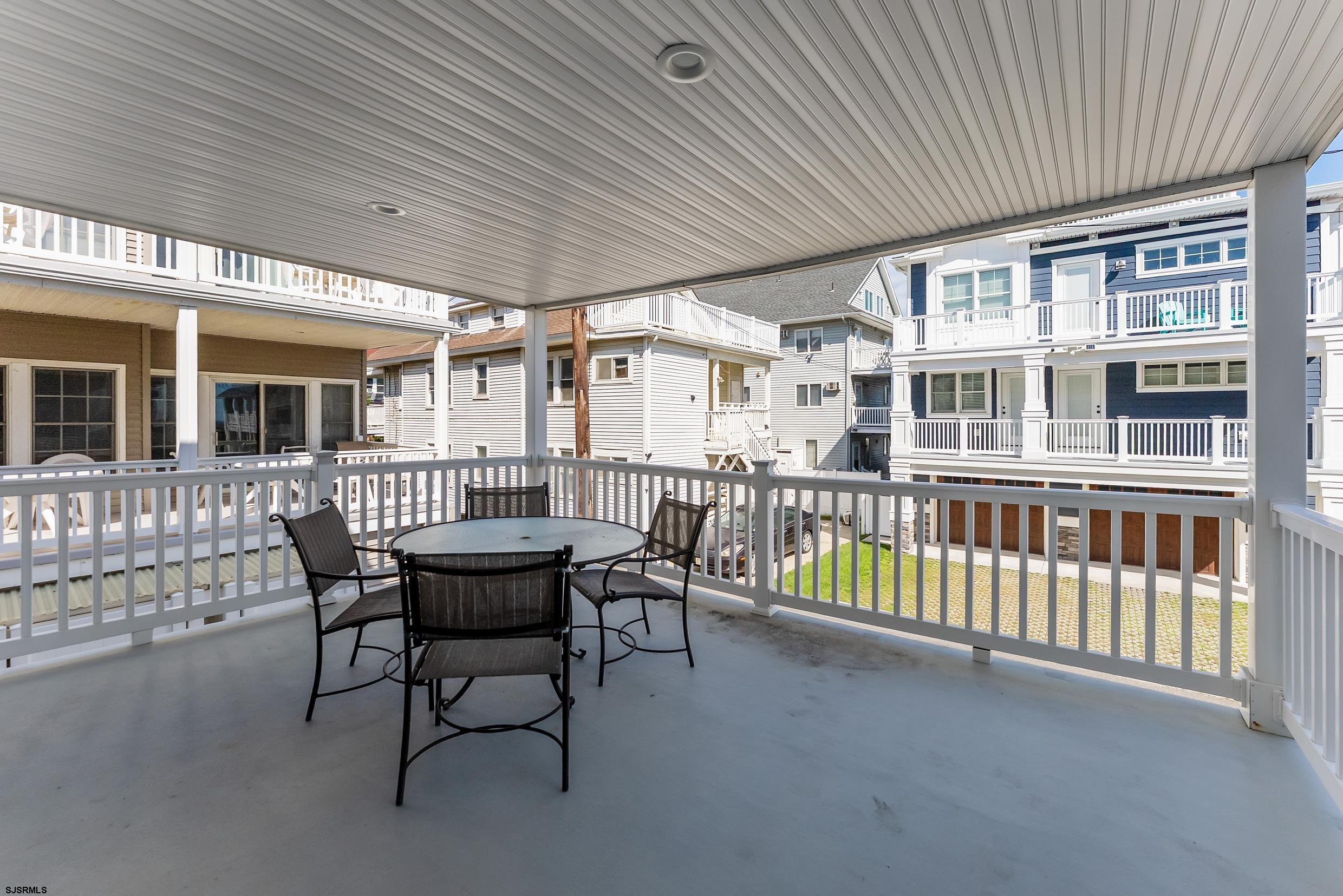 909 East 4th Street, Unit 1 Ocean City, NJ 08226 - Photo 35 of 47 a view of a chairs and table in the back yard of the house