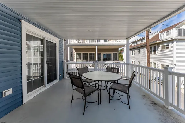 a view of a dining room with furniture and window