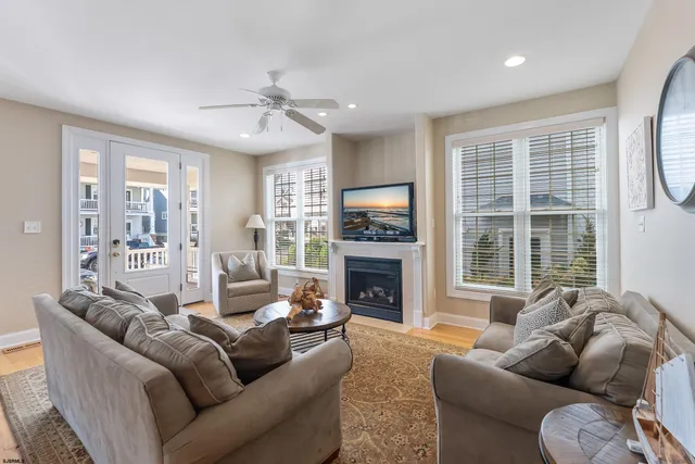 a living room with furniture fireplace and a large window