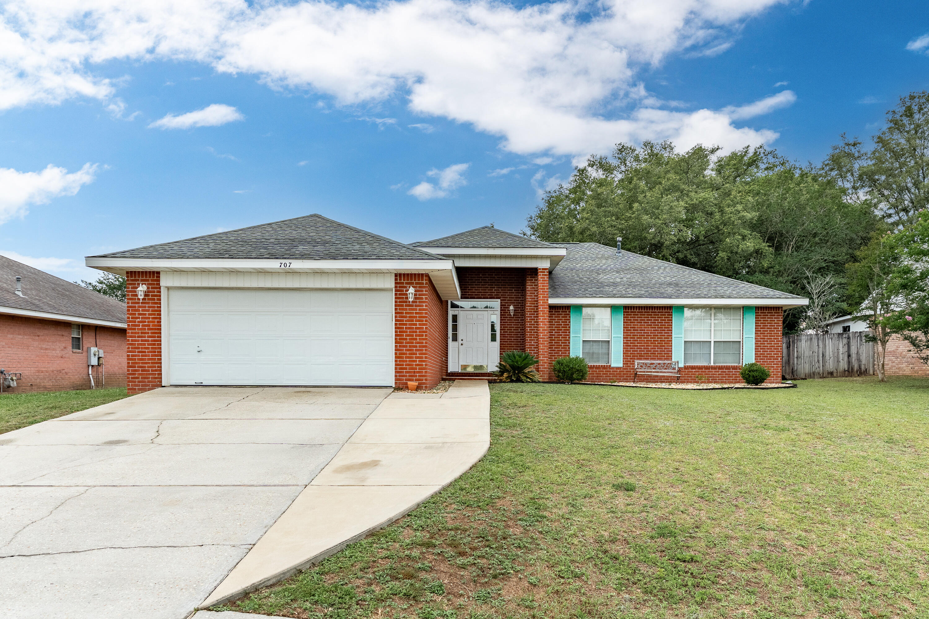 707 Riva Ridge Drive Crestview, FL 32539 - Photo 1 of 33 a front view of a house with a garden