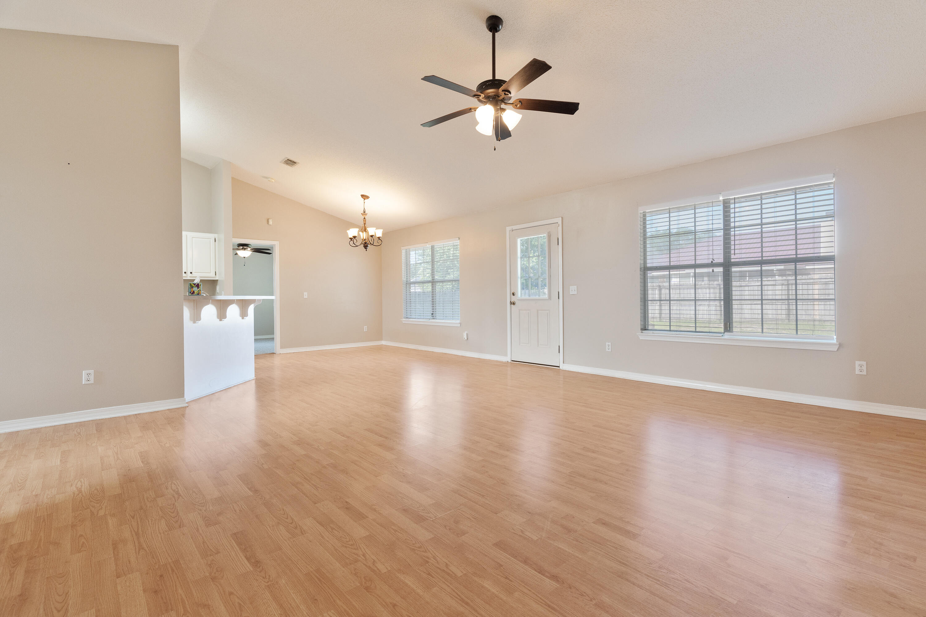 707 Riva Ridge Drive Crestview, FL 32539 - Photo 7 of 33 a view of an empty room with window and wooden floor