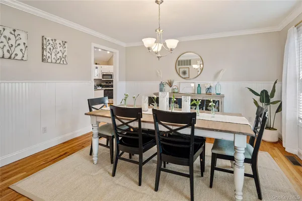 a view of a dining room with furniture and a chandelier