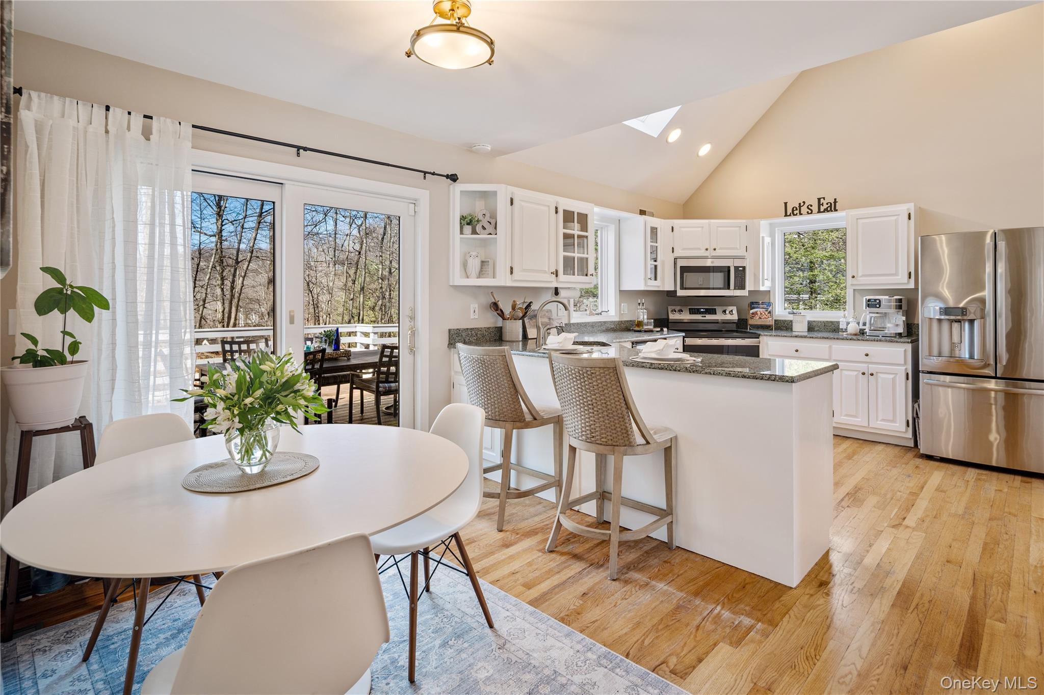 15 Cross Road Cortlandt Manor, NY 10567 - Photo 16 of 50 a kitchen with stainless steel appliances a dining table a stove top oven a dining table and chairs
