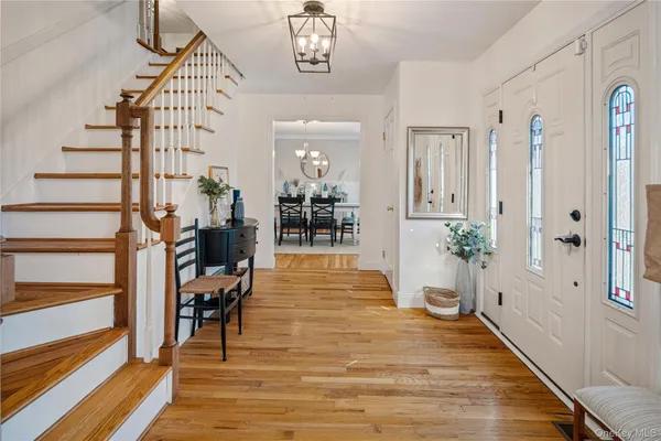 a view of a hallway with wooden floor and windows