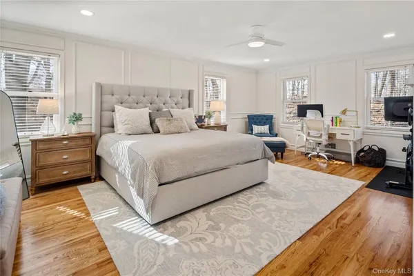 a bedroom with a bed and a flat screen television