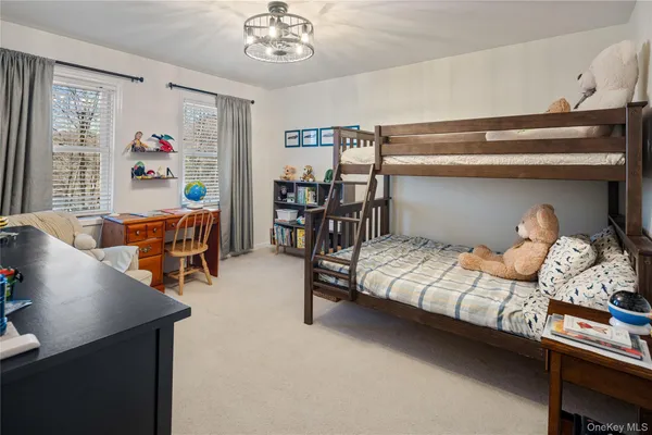 a bedroom with furniture and a chandelier