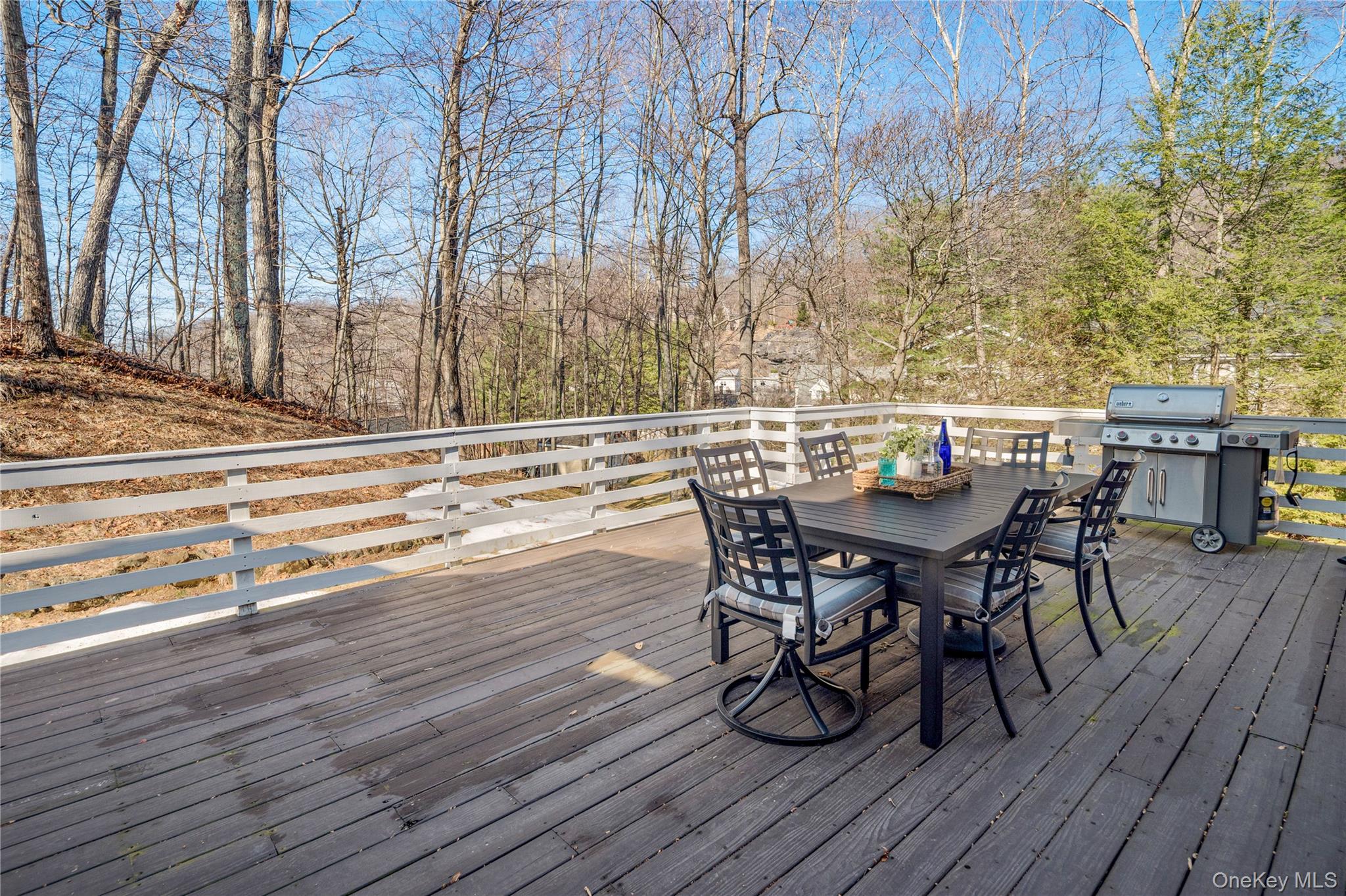 15 Cross Road Cortlandt Manor, NY 10567 - Photo 39 of 50 a view of a roof deck with table and chairs couches with wooden floor and fence