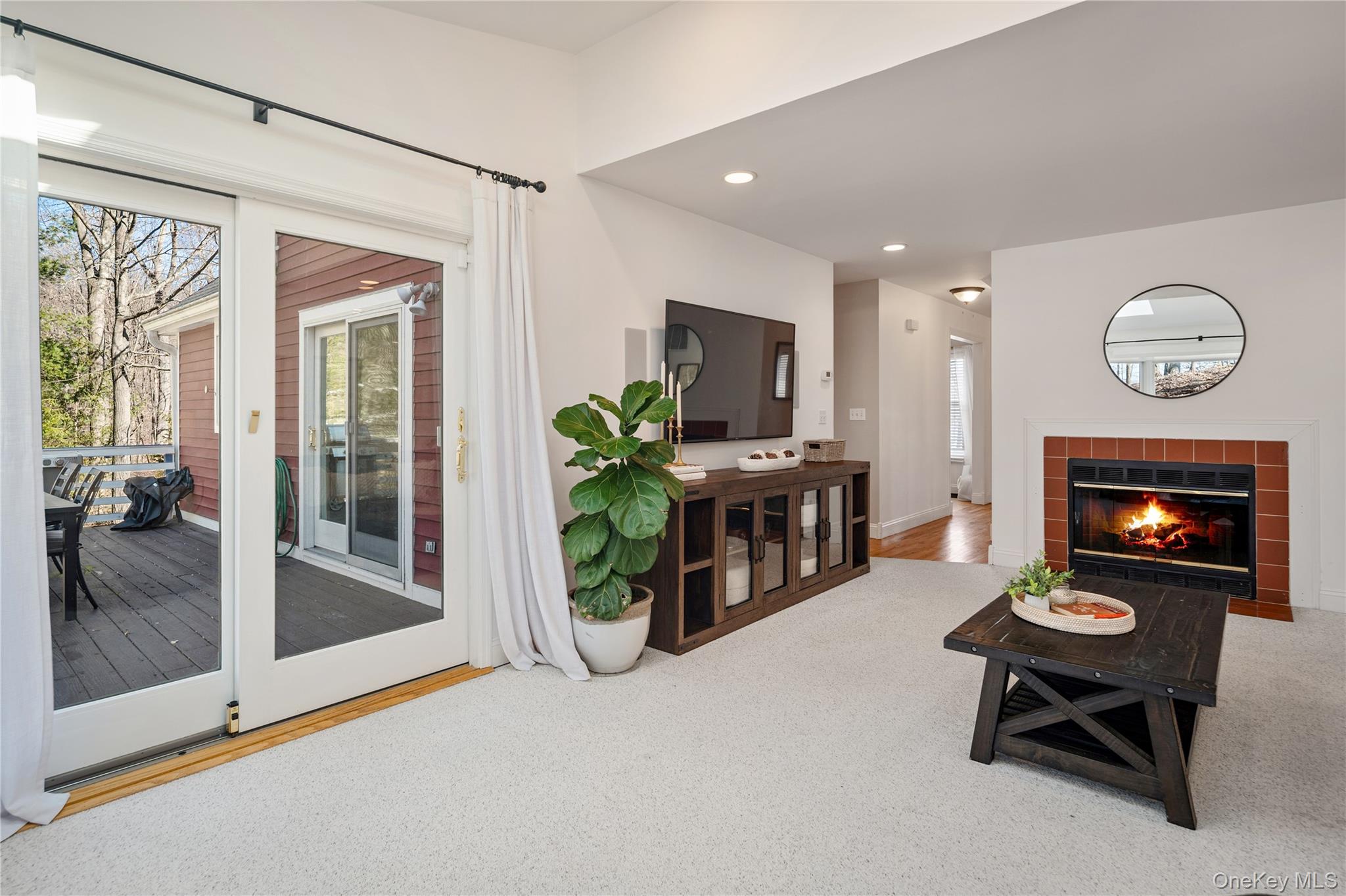 15 Cross Road Cortlandt Manor, NY 10567 - Photo 10 of 50 a living room with furniture a fireplace and a flat screen tv