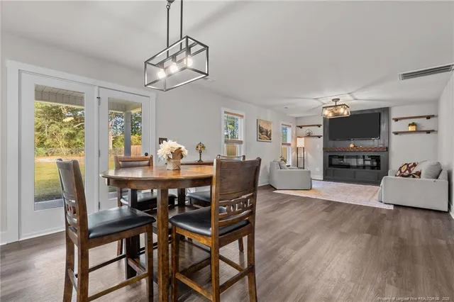 a view of a dining room with furniture window and wooden floor