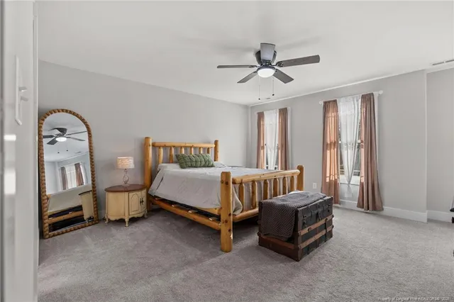 a spacious bedroom with a bed and a window