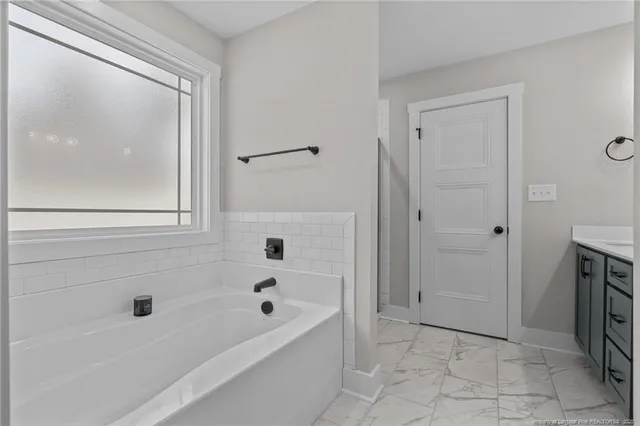 a bathroom with a bathtub and a shower