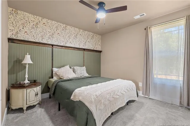 a bedroom with a bed and a mirror