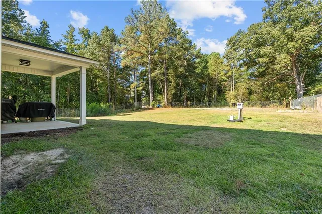 a view of outdoor space with deck and yard