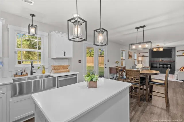 a large kitchen with a table and chairs