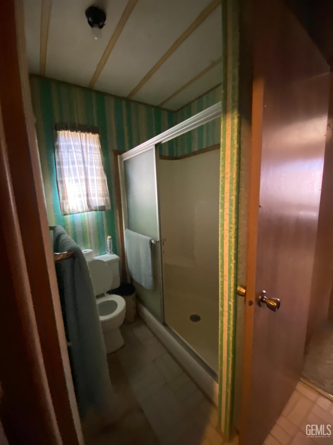 Undisclosed Address Caliente, CA 93518 - Photo 9 of 19 a bathroom with a glass door shower and toilet