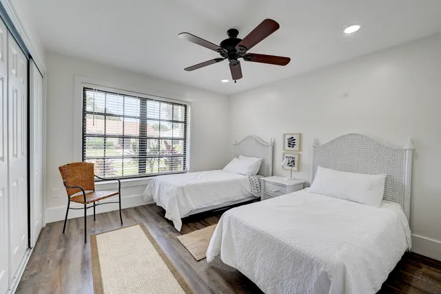 a bedroom with two beds and a window
