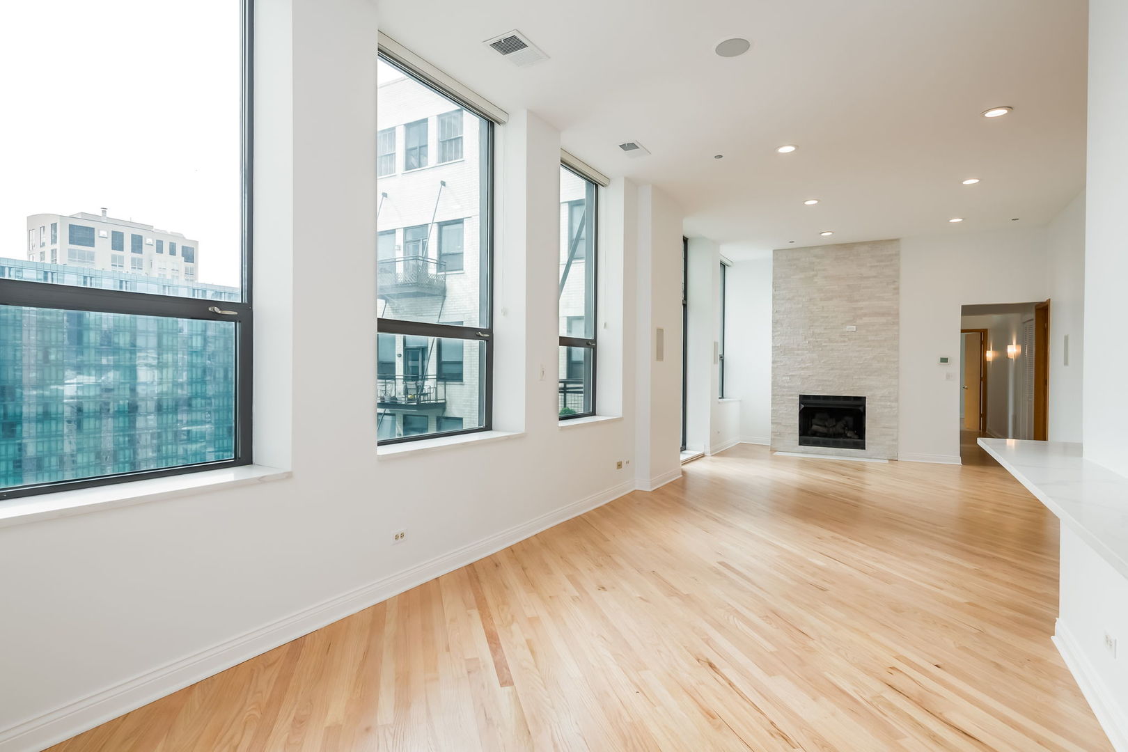 910 South Michigan Avenue, Unit 1908 Chicago, IL 60605 - Photo 3 of 29 a view of an empty room with wooden floor and a window