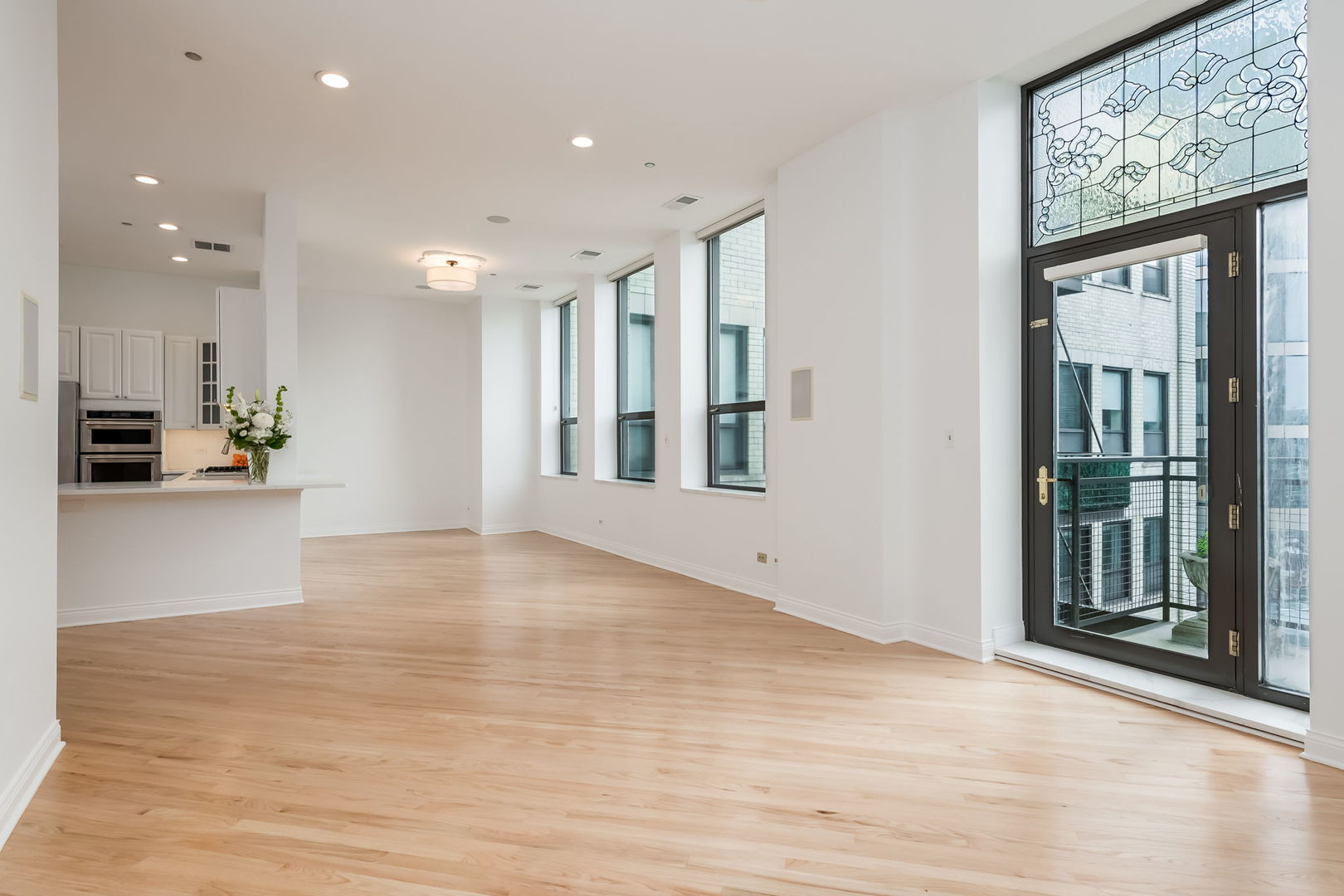 910 South Michigan Avenue, Unit 1908 Chicago, IL 60605 - Photo 4 of 29 a view of an empty room with wooden floor and a window