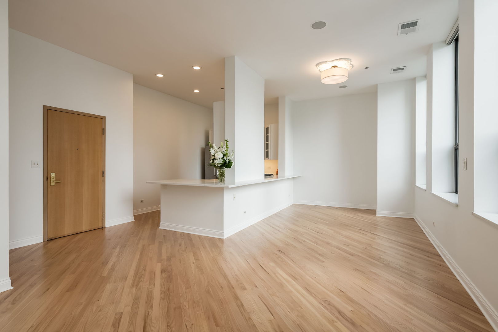 910 South Michigan Avenue, Unit 1908 Chicago, IL 60605 - Photo 5 of 29 wooden floor in an empty room with a window
