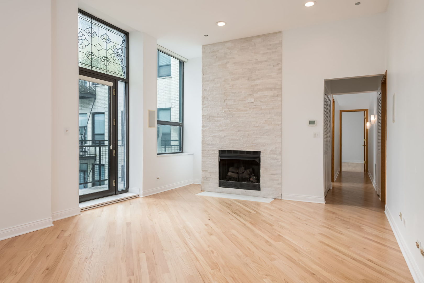 910 South Michigan Avenue, Unit 1908 Chicago, IL 60605 - Photo 9 of 29 a view of an empty room with glass door and wooden floor