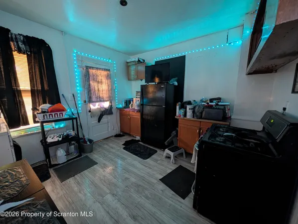 a room with furniture a flat screen tv and a window