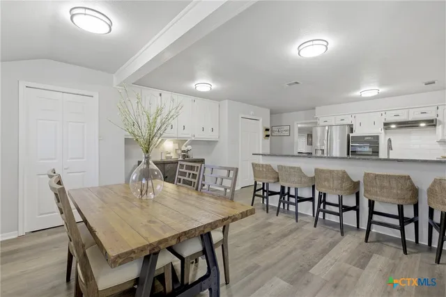 a kitchen with stainless steel appliances a refrigerator and cabinets