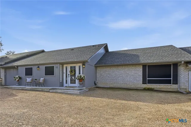 an aerial view of a houses with a yard and lake view