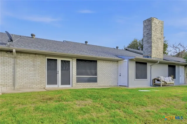 an aerial view of residential house with green space