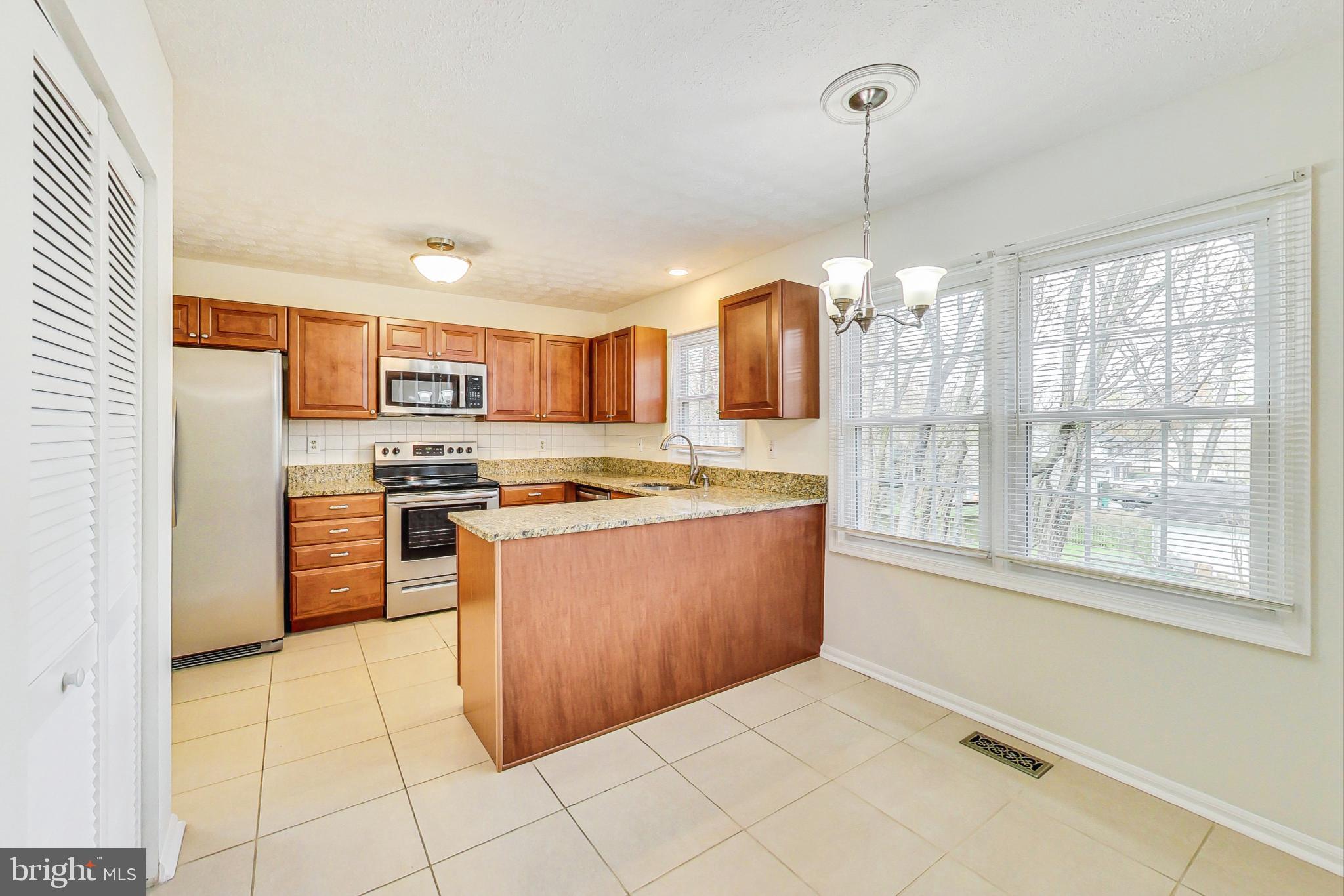 11718 Whittier Road Bowie, MD 20721 - Photo 19 of 70 Kitchen - Dining Area with Chandelier