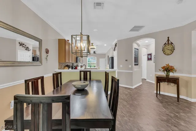 a kitchen with stainless steel appliances a sink a stove top oven a counter space and cabinets